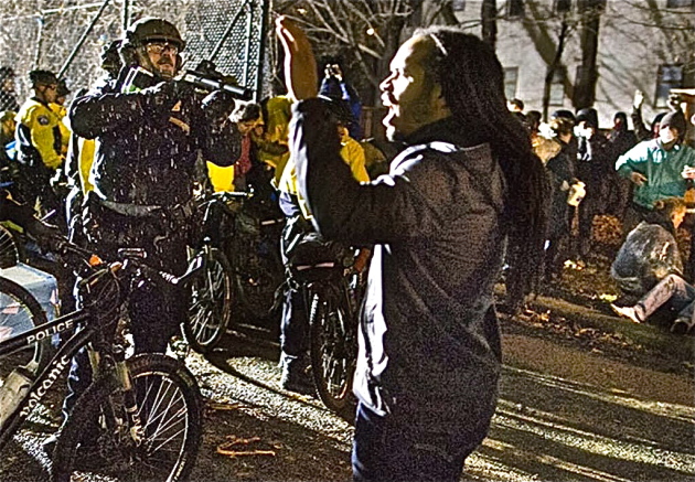 Jeremiah Bey peacefully protesting with his hands up while MPD overreact with force. (Photo courtesy of Wintana Melekin)